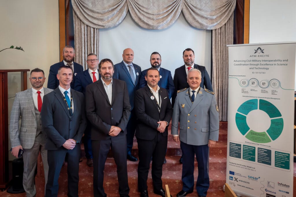 Project roll-up banner displayed during the ATM-EXCITE at NTAD 2025 presentation, showcasing civil-military interoperability solutions and cybersecurity technologies.